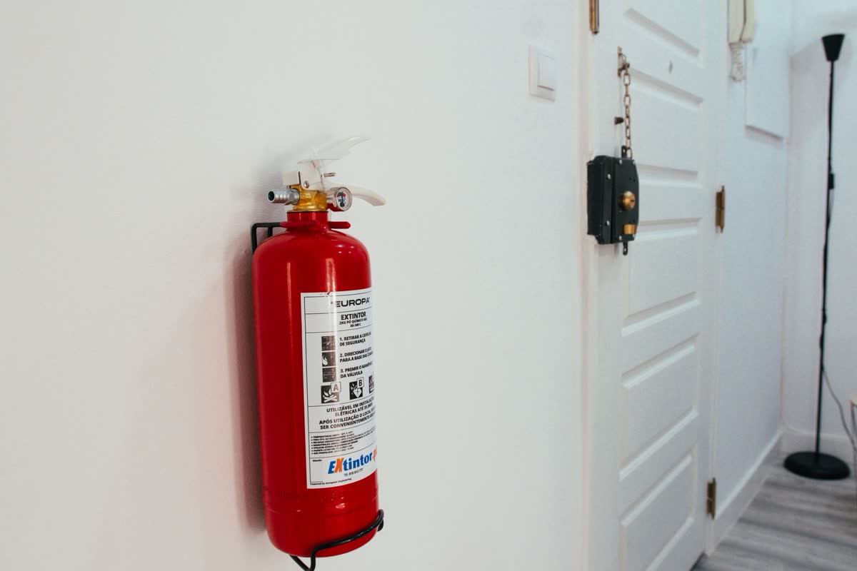 A red fire extinguisher mounted on a wall