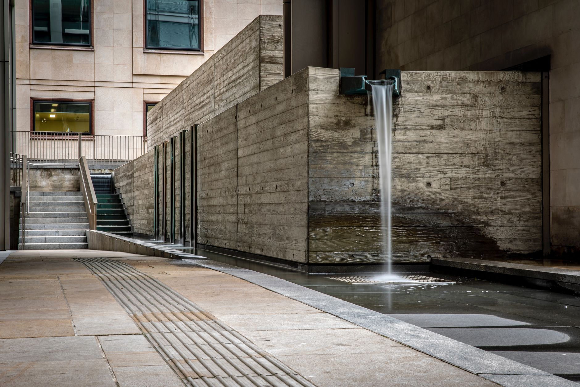 Water running freely from a downspout after cleaning