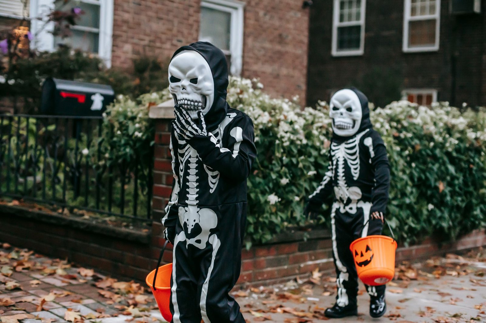 Kids in skeleton costumes trick-or-treating